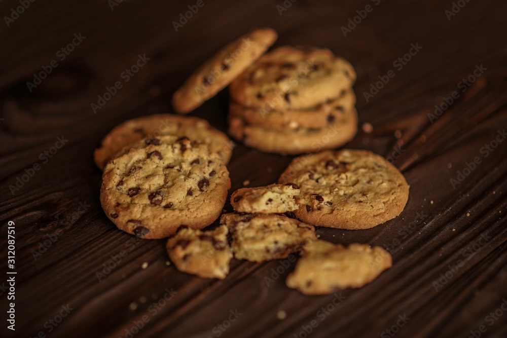 shortbread cookies with peanuts and chocolate on a wooden brown background. close-up.