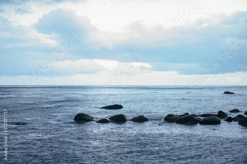 panoramic view of the sea coast with stones and thunderclouds