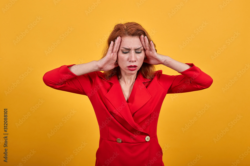 Confused caucasian young woman keeping hand on head, having headache, screaming wearing fashion red jacket over isolated orange background. People lifestyle concept. Confused caucasian young woman keeping hand on head, having headache, screaming wearing fashion red jacket over isolated orange background. People lifestyle concept.
