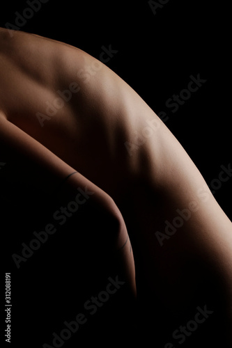 Skinny naked girl stands sideways visible ribs, nude. 