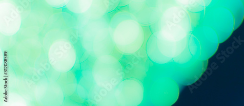 Abstract Bokeh Blue and green background of defocused glittering lights. Christmas, Party, New Year, luxurious background pattern concept. banner.
