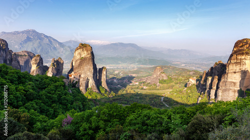 Wonderful Panoramic view of Meteora. Majestic sunny landscape with colorful sky over the fairytale mountain valley in Greece. Amazing spring scene of Famouse Kalabaka location, Greece, Europe.