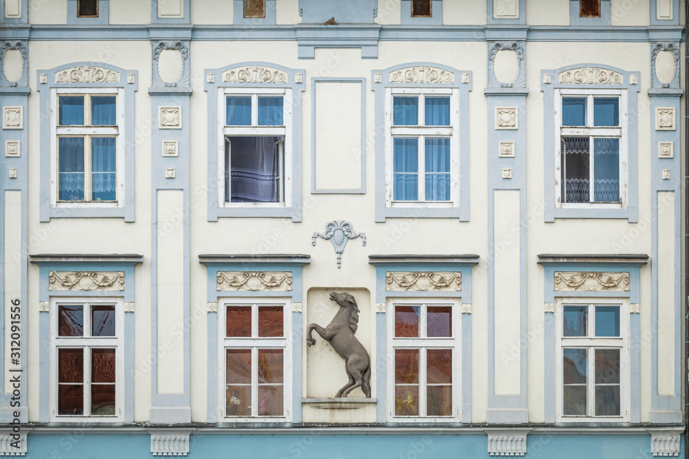 Blue and white facade of the old house. The Windows and decoration of walls in Litomerice, Czechia
