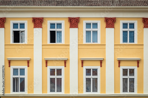 Obraz na płótnie Yellow facade of the old house. The Windows and decoration of walls in Litomerice, Czechia w salonie