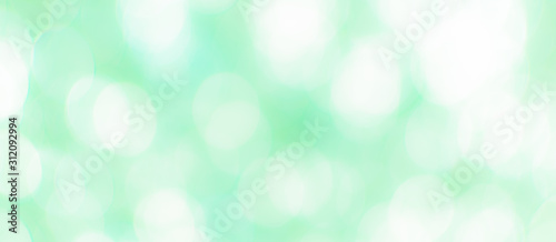 Abstract Bokeh Blue and green background of defocused glittering lights. Christmas, Party, New Year, luxurious background pattern concept. banner.
