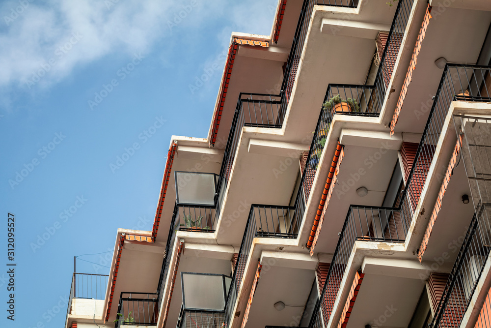 Typical Spanish apartment buildings on a sunny day with a blue sky. Facade of a modern apartment building in Valencia