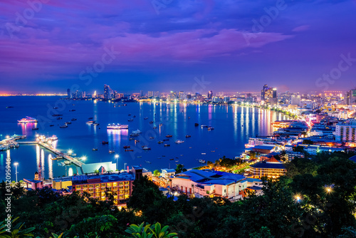 High view on viewpoint see cityscape with colorful light at the beach and the sea of ​​Pattaya Bay, beautiful landscape of Pattaya City at night scene landmark in Chonburi, Travel Asia to Thailand