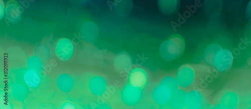 Abstract Bokeh Blue and green background of defocused glittering lights. Christmas, Party, New Year, luxurious background pattern concept. banner.
