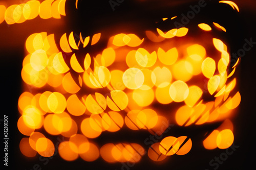 silhouette of the symbol of love - hearts against the bright orange blurred lights
