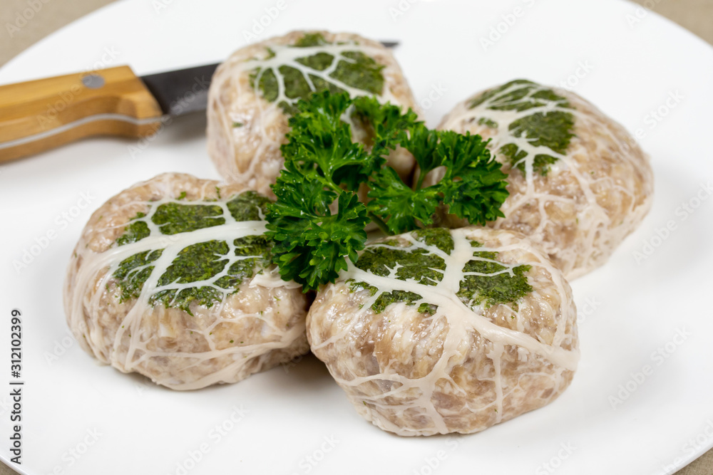 several raw crepinette on a plate several raw crepinette on a plate