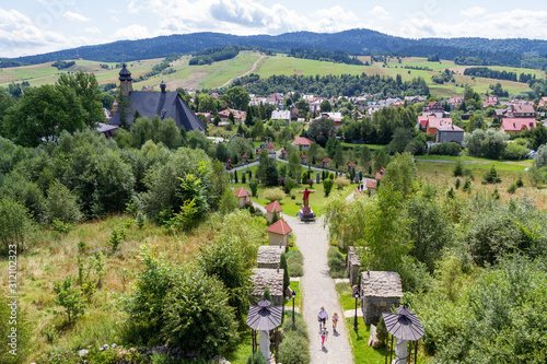 Tylicz, Poland. 2019/8/8. The way of the Cross and the Sanctuary of Our Lady of Tylicz as seen from the top of the Golgotha. photo