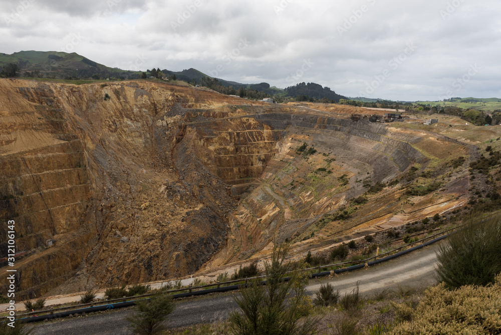 Obraz premium Open-cast gold mine in Waihi, Hauraki, New Zealand. A huge landslide can be seen on the far wall of the pit.