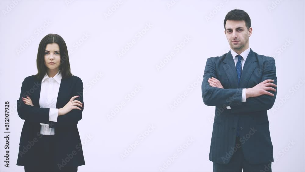 Business man and woman standing, their hands folded, looking with confident face expression. Business man and woman standing, their hands folded, looking with confident face expression.