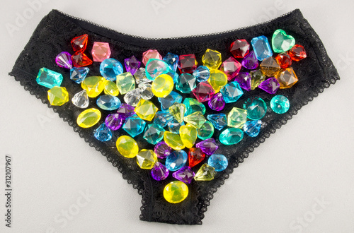 Black lace panties with gems on a gray background