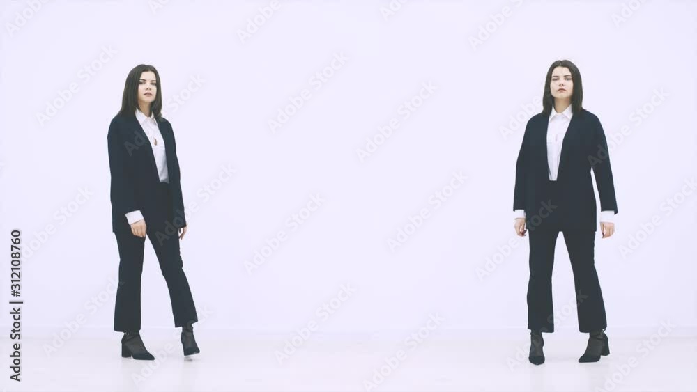 Two businesswomen appearing on the white background, using different gestures, giving thumb up, pointing finger. Two businesswomen appearing on the white background, using different gestures, giving thumb up, pointing finger.