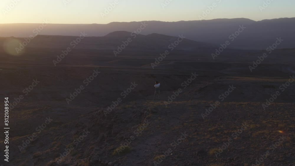 dark scene of photography wielded photographic camera to capture the sunset, Atacama, Chile dark scene of photography wielded photographic camera to capture the sunset, Atacama, Chile