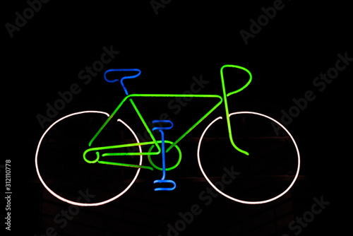 Bicycle silhouette shape from LED strip on a dark background. photo