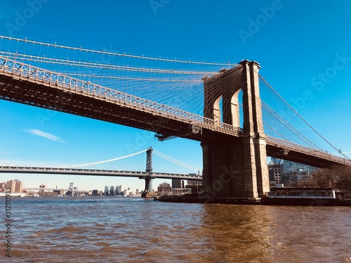 Fototapeta Naklejka Na Ścianę i Meble -  Brooklyn Bridge towering over Hudson river