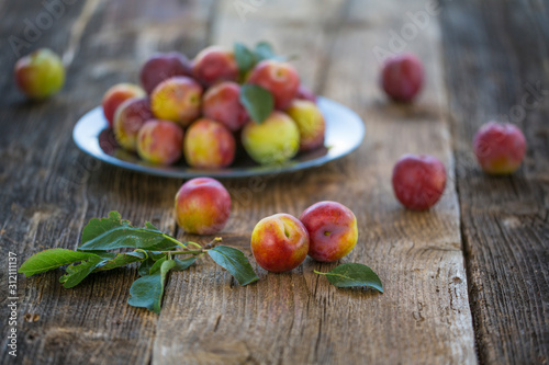 Sweet plums on wooden background