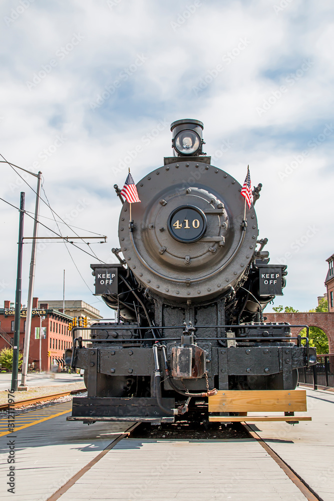 Fototapeta premium Old steam train in the middle of a town
