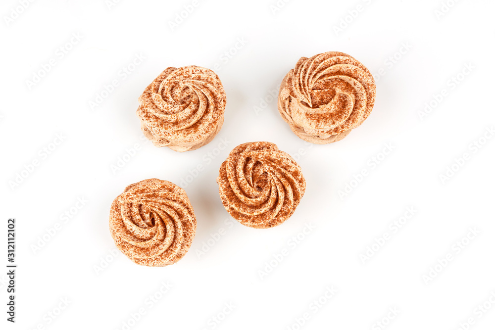 Four marshmallows, sprinkled with cinnamon and chocolate, lie on a white background. Top view isolated on white background. Four marshmallows, sprinkled with cinnamon and chocolate, lie on a white background. Top view isolated on white background.