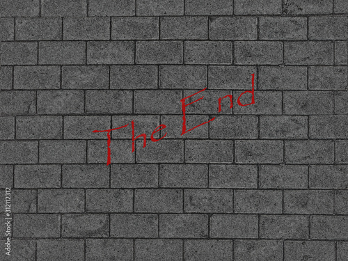 Abstract background brick wall with sign The End and copy space