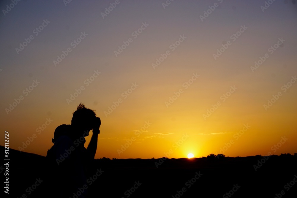 desert silhouette of a man in the sunset