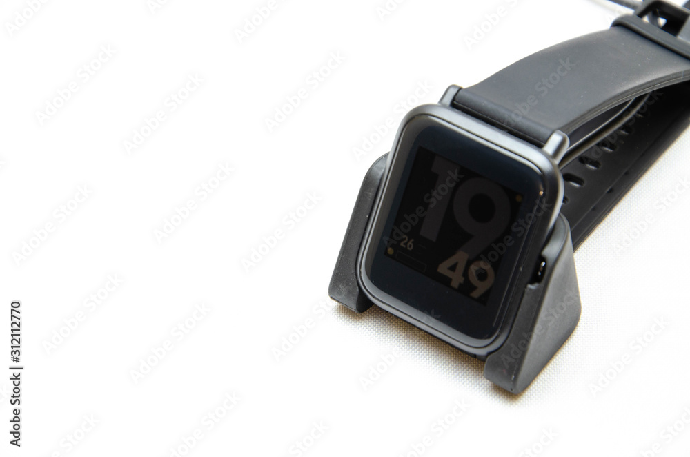 Smart watch on hand. Smart watch on a white background. Charger for smart watches. Dock station. Men's hands hold a smart watch and put them on charge. Watch, charger in close-up Smart watch on hand. Smart watch on a white background. Charger for smart watches. Dock station. Men's hands hold a smart watch and put them on charge. Watch, charger in close-up