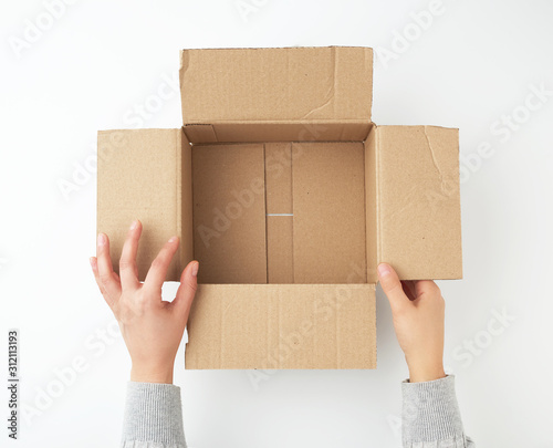 open empty square brown cardboard box for transportation and packaging of goods