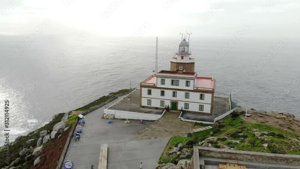 Aerial drone view of the Finisterre lighthouse in Spain at the so-called end of the world. It is the end point of the Saint James Walk for pilgrims. It is a winter day on the Atlantic with high waves. Aerial drone view of the Finisterre lighthouse in Spain at the so-called end of the world. It is the end point of the Saint James Walk for pilgrims. It is a winter day on the Atlantic with high waves.