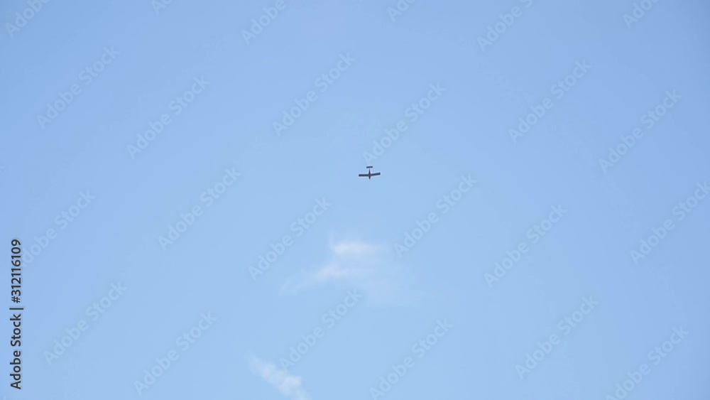 small plane flies against the blue sky slow motion small plane flies against the blue sky slow motion