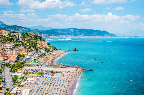 Fototapeta Naklejka Na Ścianę i Meble -  Vietri sul mare beautiful view from above to beaches with umbrellas, rocks due fratelli, blue sea and city and mountains