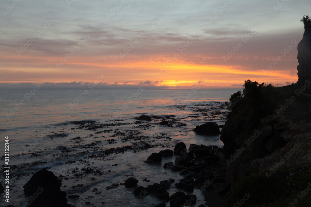 Oamaru, New Zealand. Cape Wanbrow Track to Second Beach. Sunrise over the bay.