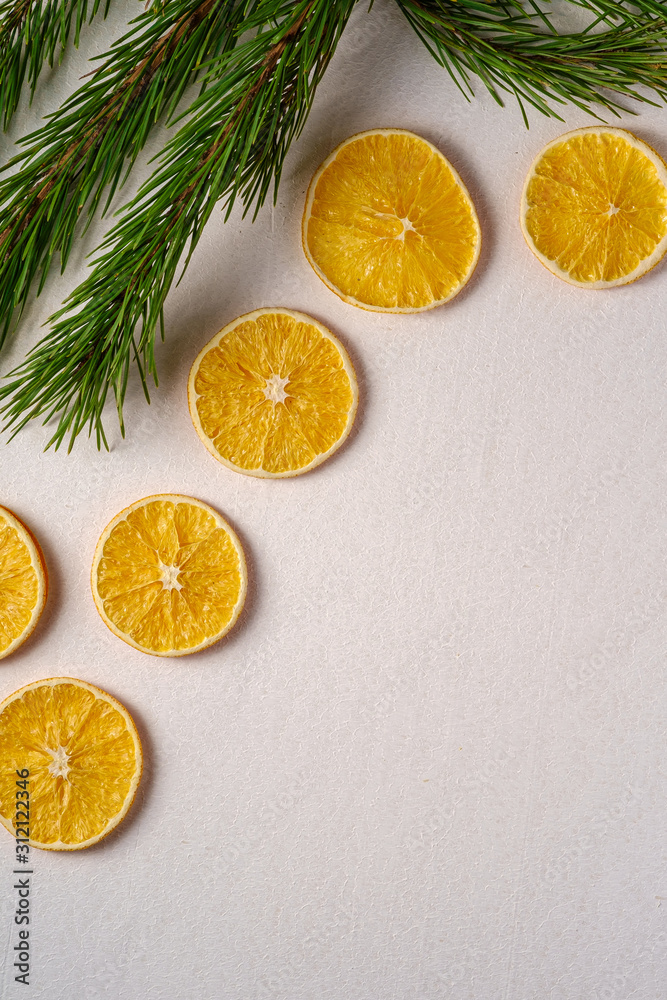 Creative holiday Christmas New Year food fruit texture with dried orange with branch of fir tree macro, top view, white background copy space Creative holiday Christmas New Year food fruit texture with dried orange with branch of fir tree macro, top view, white background copy space
