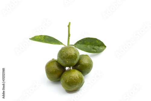 Calamansi lime with green leaf on isolated background