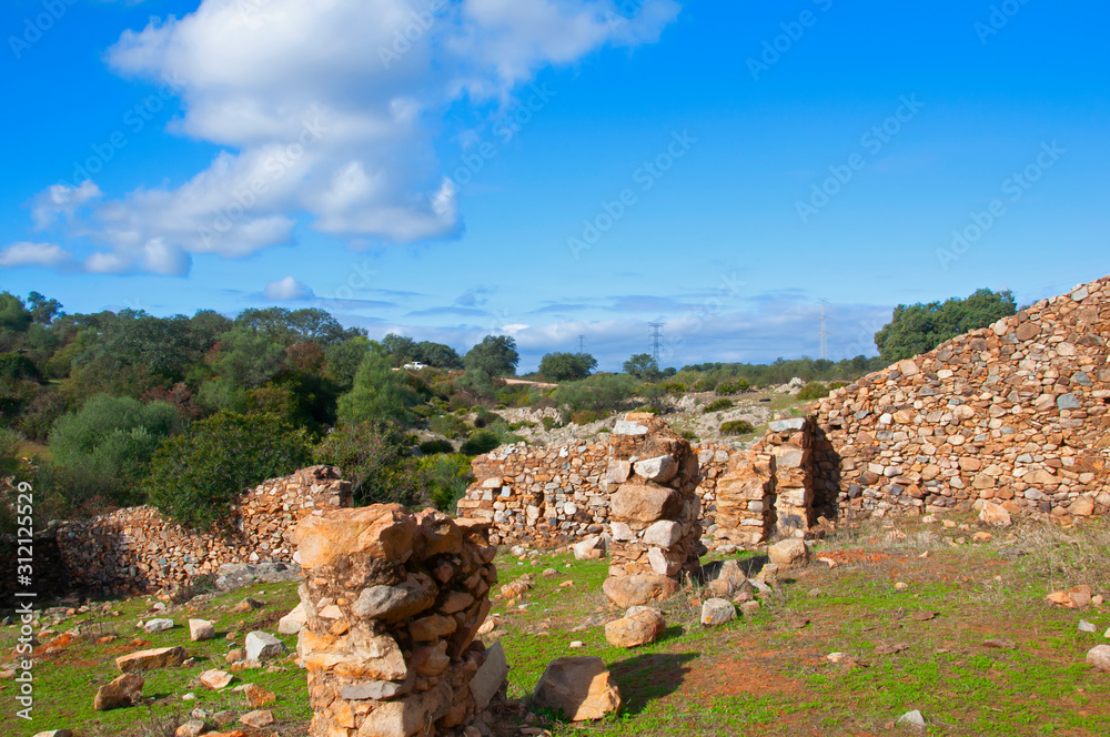 The remains of a destroyed house in the green field in Seville, Spain