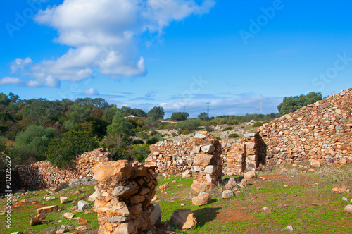 The remains of a destroyed house in the green field in Seville, Spain