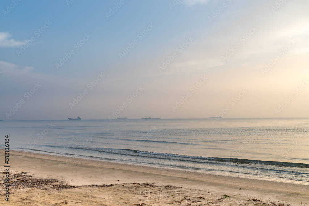 Sunrise at sand beach at Mediterranean sea