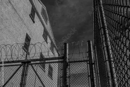 Scene inside Kingston Penitentiary showing stone building fences and razor wire nobody