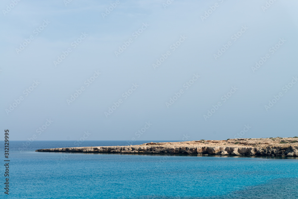 Curved rocky seashore and transparent water of Mediterranean sea