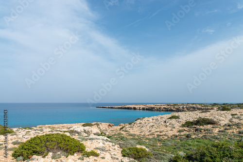 Curved rocky seashore and transparent water of Mediterranean sea