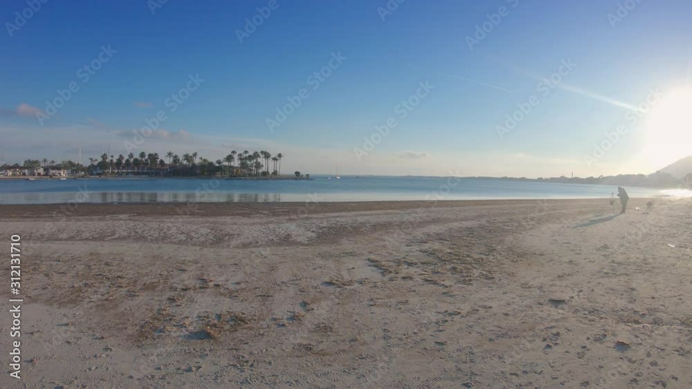 Panoramic view of sea bay and wide abandoned beach with white sand. Sun in the backlight. Winter in Mallorca, Balearic islands, Spain. 4K footage Panoramic view of sea bay and wide abandoned beach with white sand. Sun in the backlight. Winter in Mallorca, Balearic islands, Spain. 4K footage