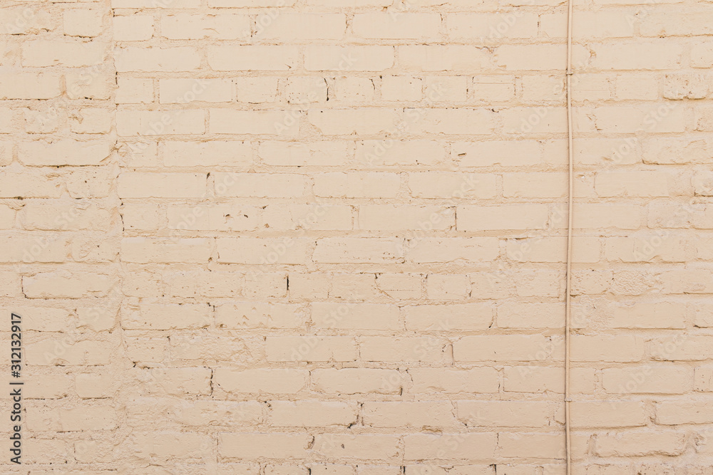 Fototapeta premium Cream brick wall background texture