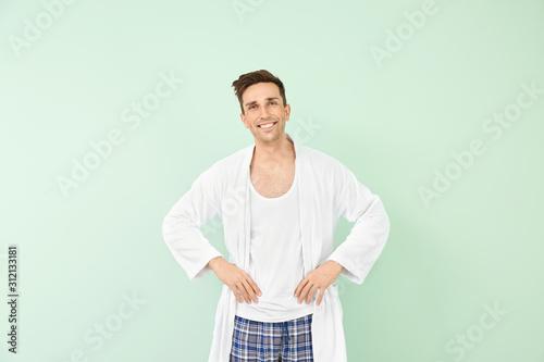 Handsome man in bathrobe on...