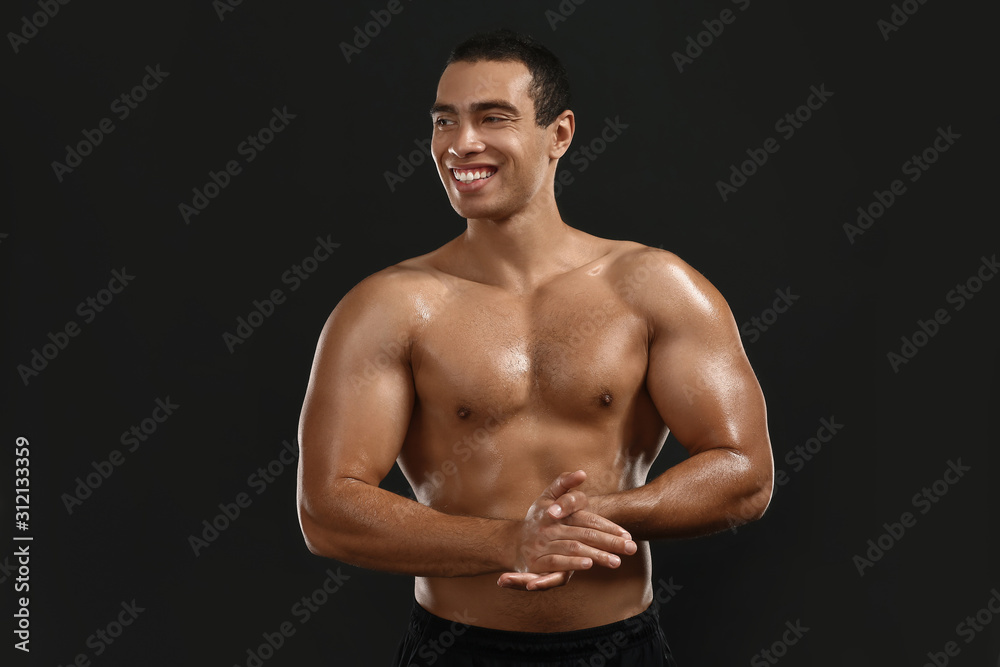 Fototapeta premium Sporty African-American man on dark background