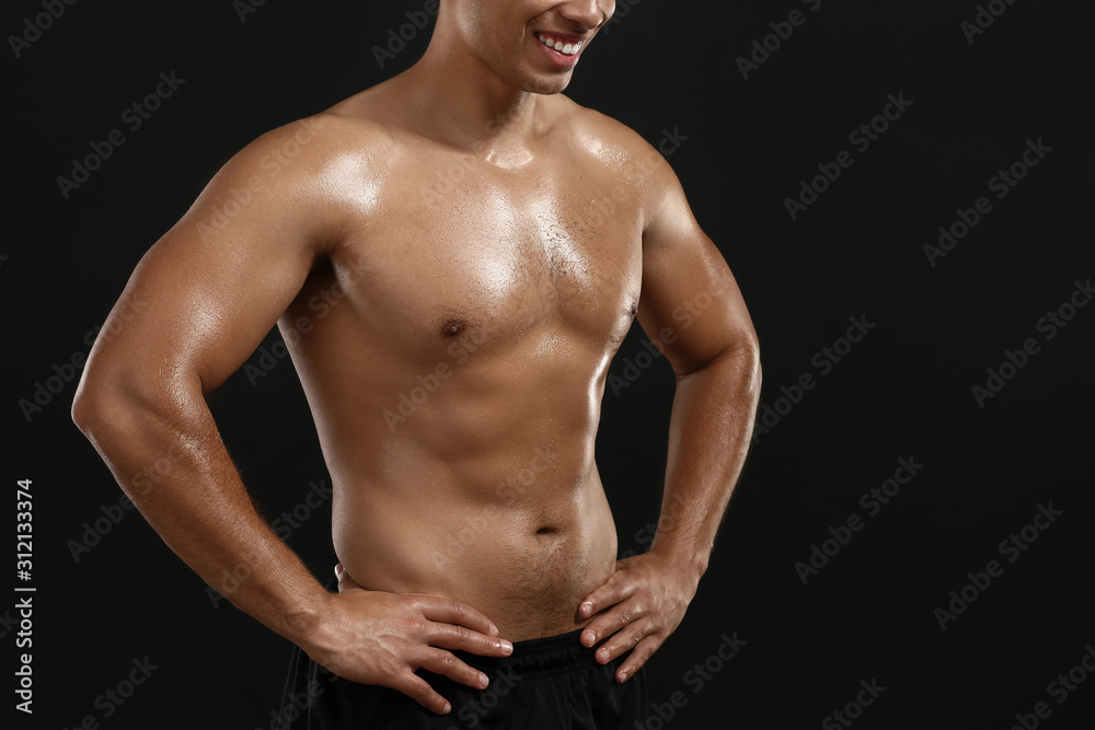 Sporty African-American man on dark background Sporty African-American man on dark background