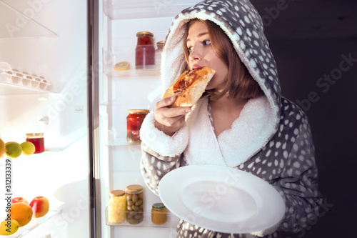 Teenage girl eating unhealt...