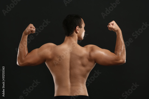 Sporty African-American man on dark background