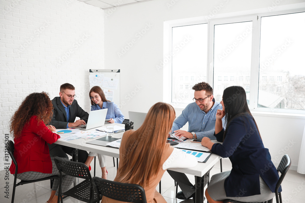 Colleagues discussing issue at business meeting in office