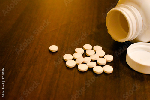 A close up view of pills and a bottle. Illegal drugs concept.  photo
